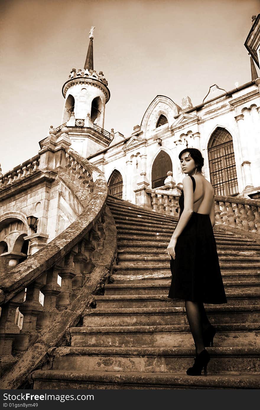 Lovely brunette beside old castle. Lovely brunette beside old castle