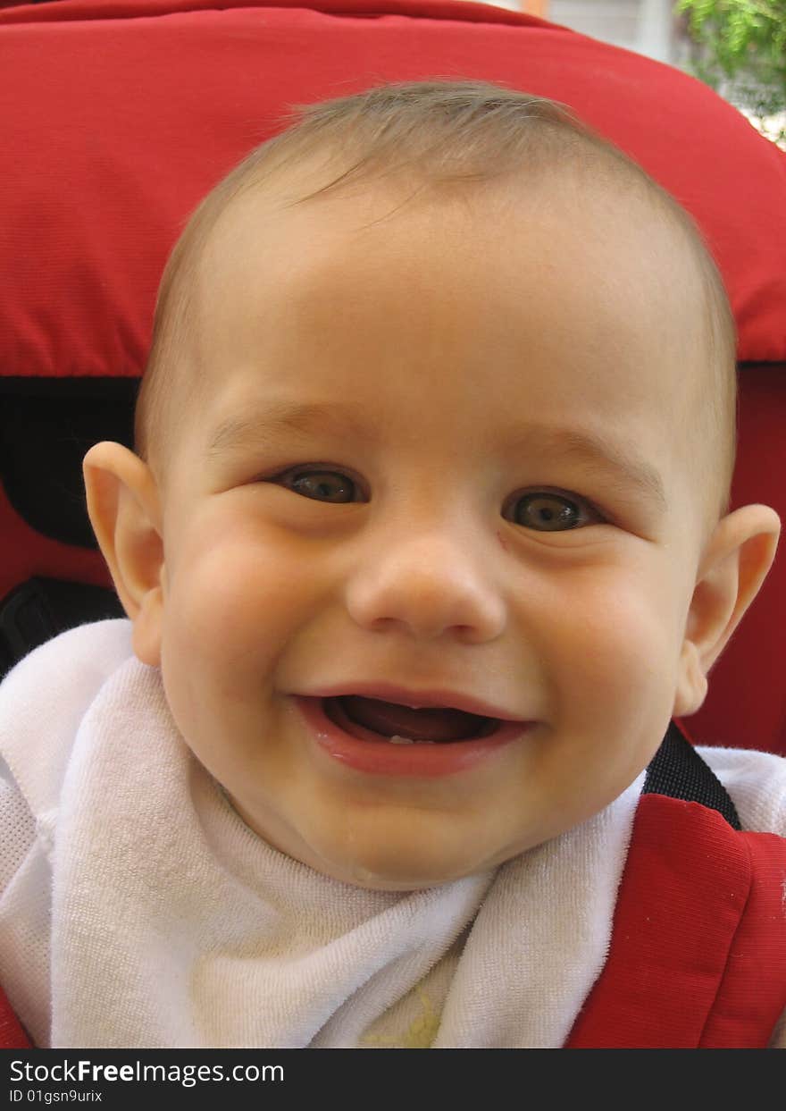 A happy little boy laughing with the camera. A happy little boy laughing with the camera.