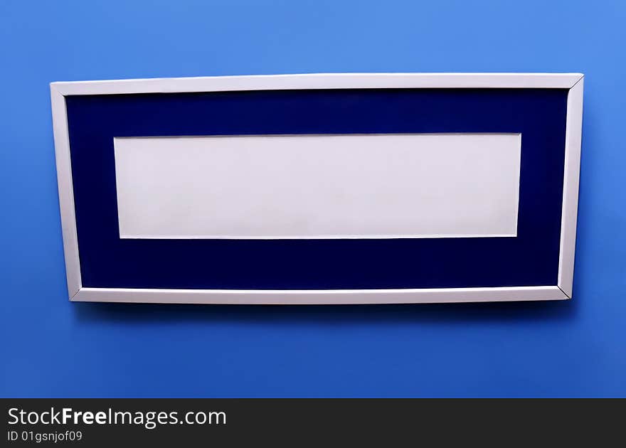 Rectangular picture frame on a blue background. Rectangular picture frame on a blue background