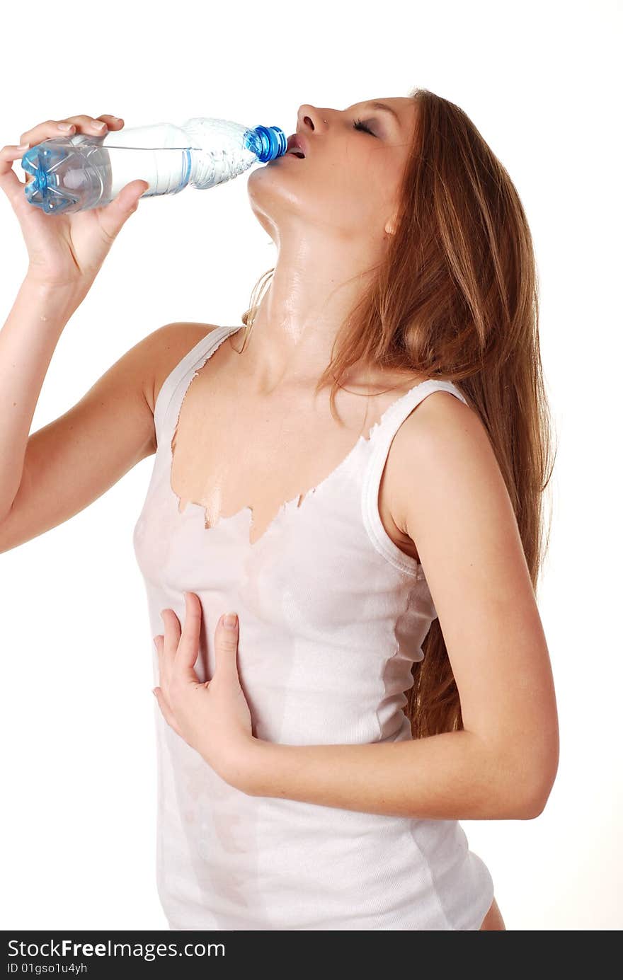 Woman in wet white shirt with bottle of water. Woman in wet white shirt with bottle of water