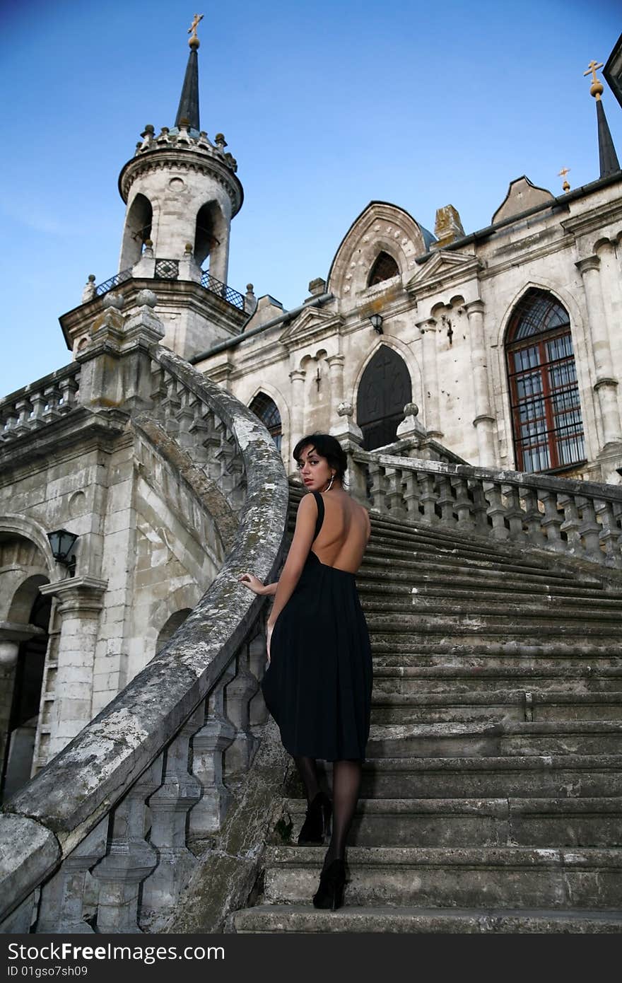 Lovely brunette beside old castle. Lovely brunette beside old castle