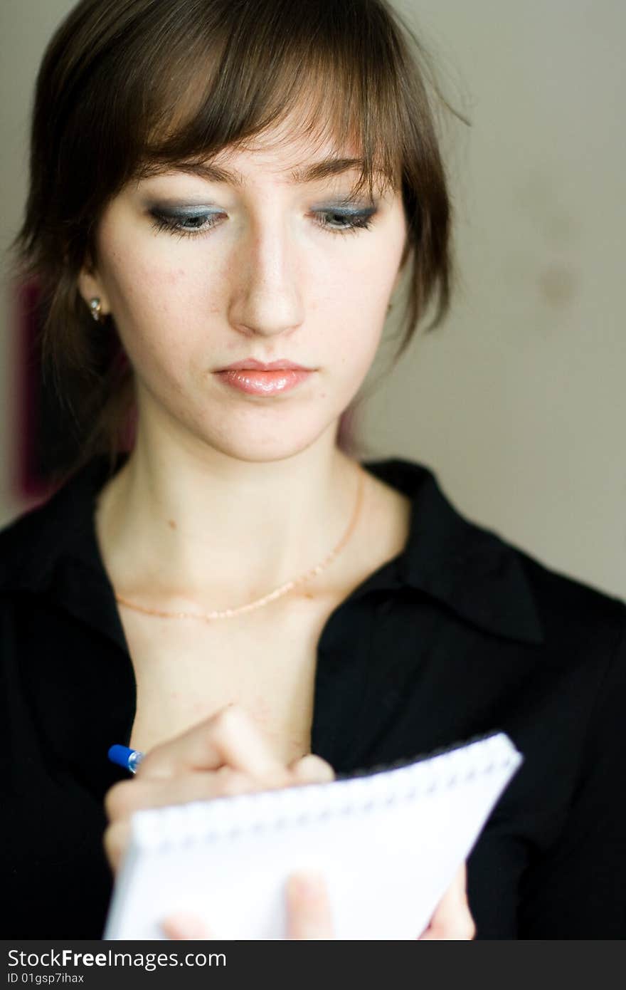 Girl a black jacket with pen. Girl a black jacket with pen