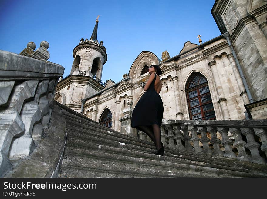 Lovely brunette beside old castle. Lovely brunette beside old castle