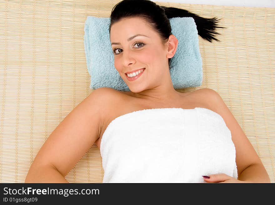 Top view of smiling young woman scrubbing her body against white background. Top view of smiling young woman scrubbing her body against white background