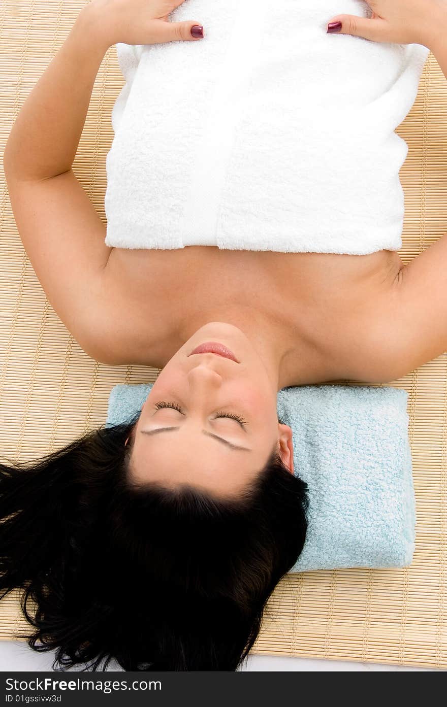 Top view of smiling young woman scrubbing her body against white background. Top view of smiling young woman scrubbing her body against white background