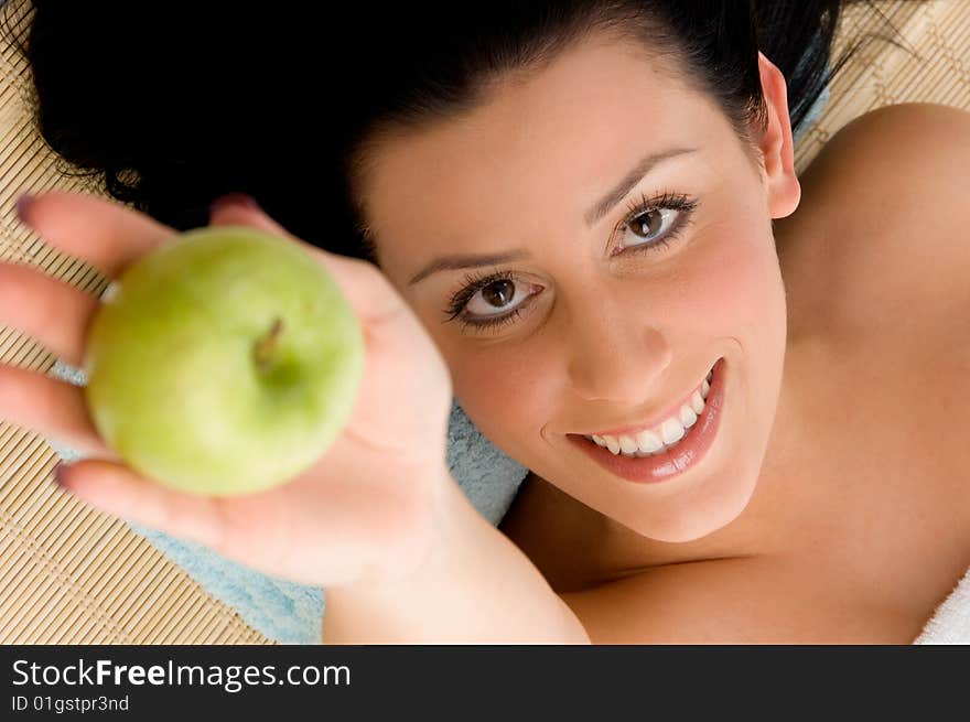 Top view of smiling young woman scrubbing her body against white background. Top view of smiling young woman scrubbing her body against white background