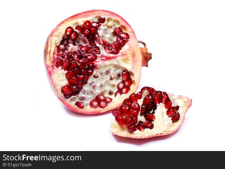 Slice of red sweet pomegranate on white background. Slice of red sweet pomegranate on white background