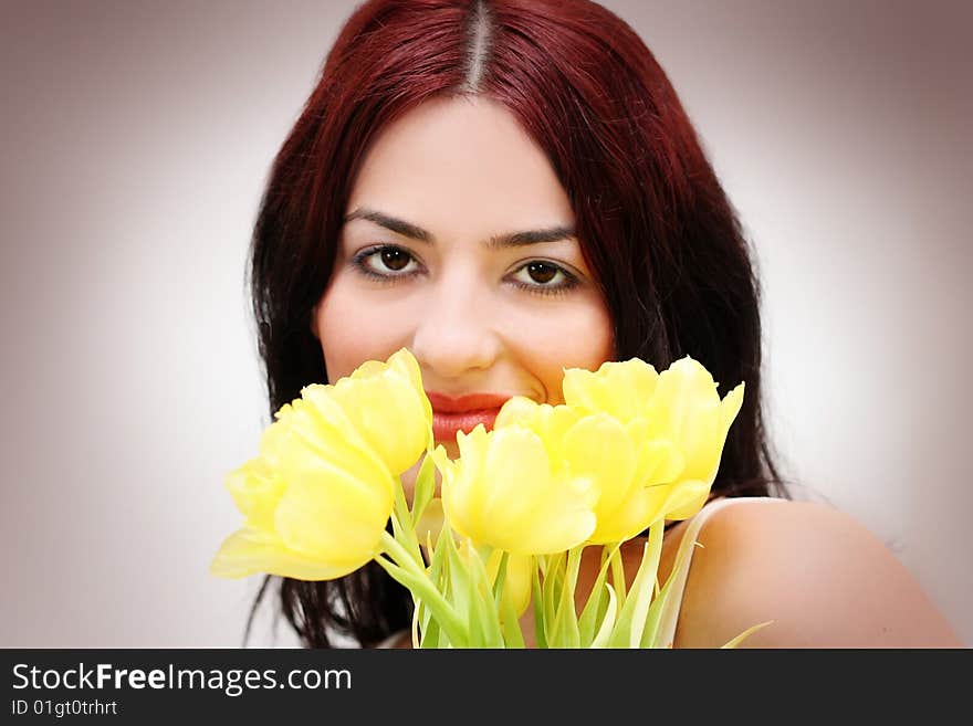 Oriental pretty girl with yellow tulips. Oriental pretty girl with yellow tulips