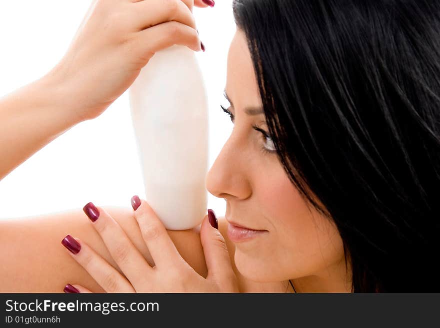 Portrait of young woman holding lotion bottle