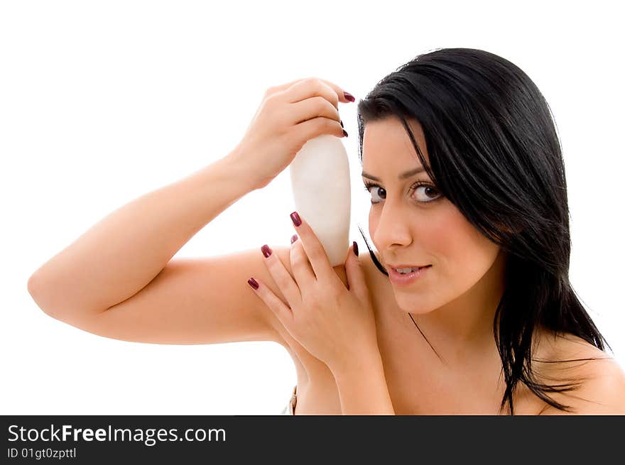 Portrait of female holding lotion bottle