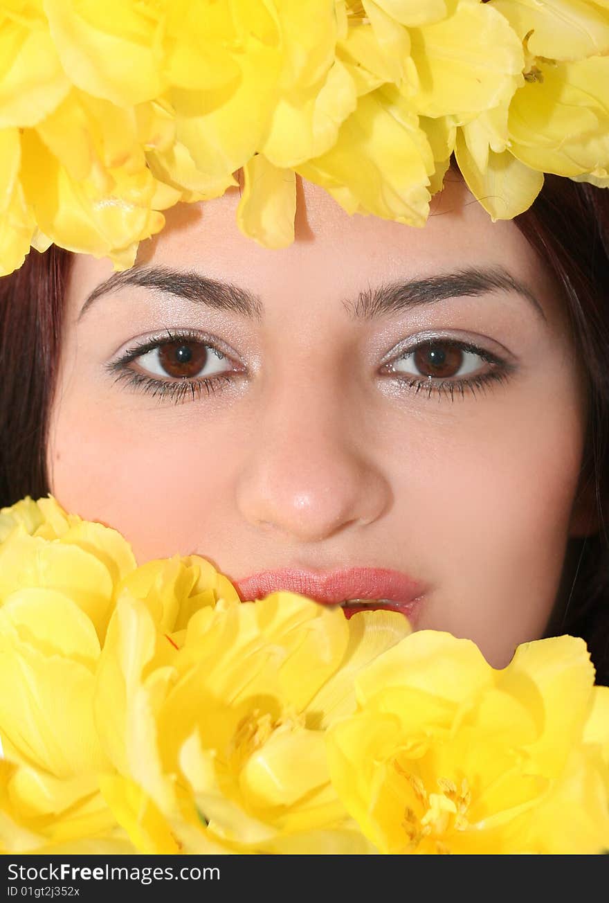 Oriental pretty girl with yellow tulips. Oriental pretty girl with yellow tulips