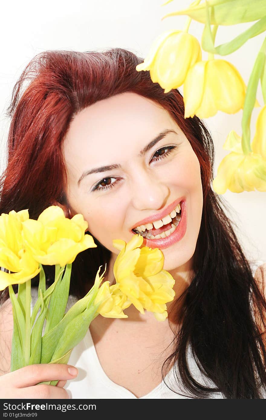 Oriental pretty girl with yellow tulips. Oriental pretty girl with yellow tulips