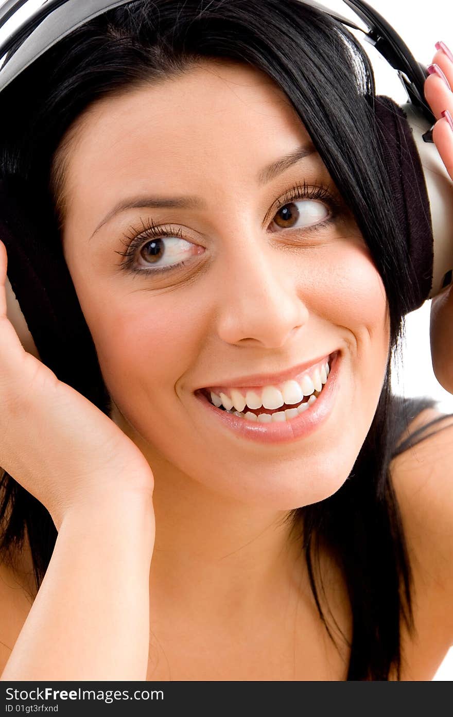 Close up of smiling young female enjoying music on an isolated background. Close up of smiling young female enjoying music on an isolated background