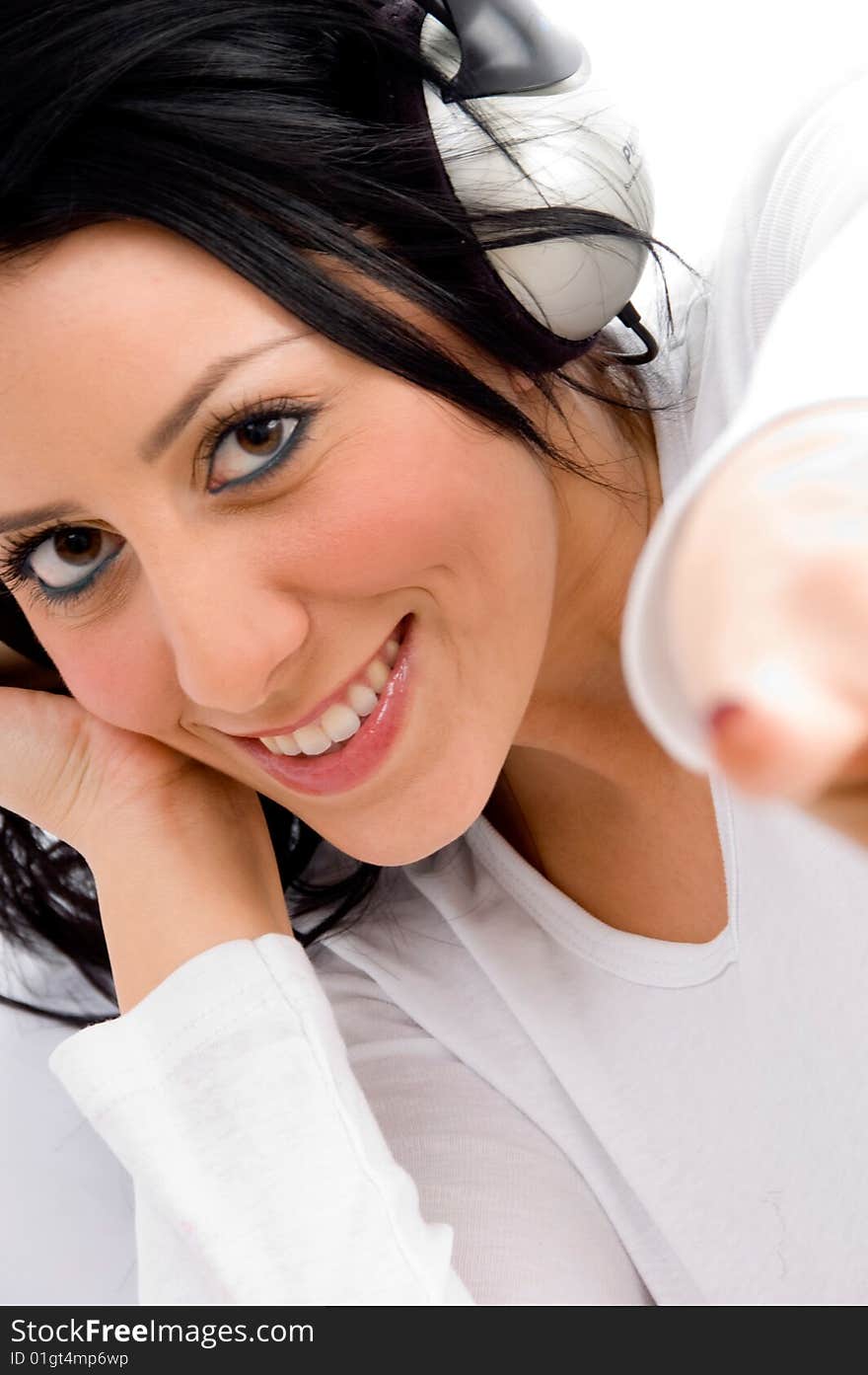 Top view of pointing young female enjoying music on an isolated white background. Top view of pointing young female enjoying music on an isolated white background