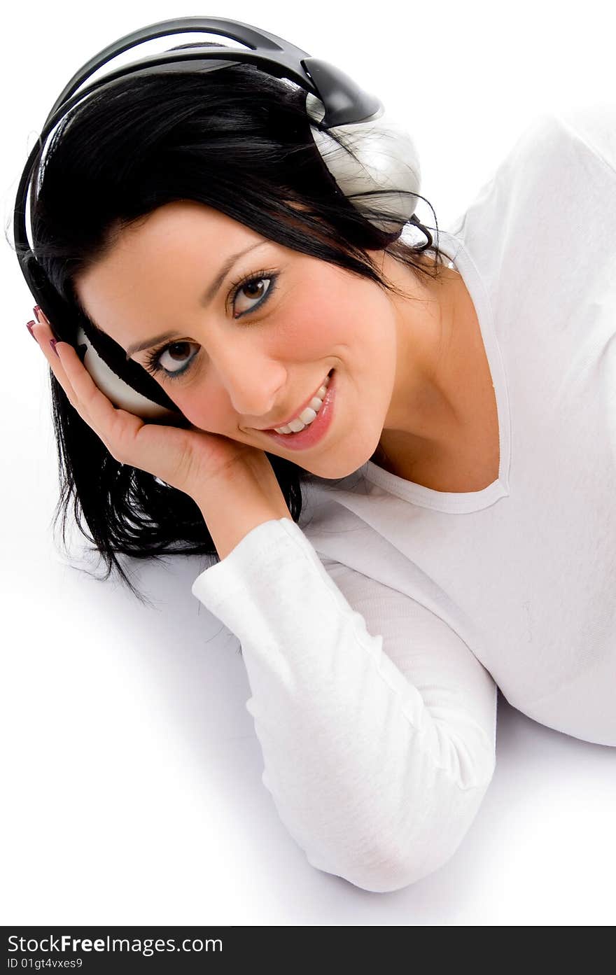 Top view of smiling female listening music on an isolated white background. Top view of smiling female listening music on an isolated white background