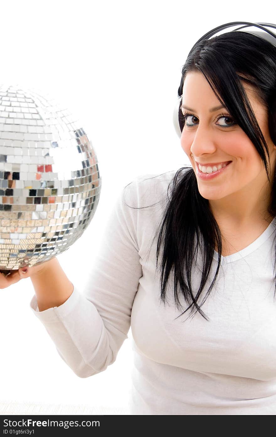 Half length view of female listening music and carrying disco ball on an isolated white background