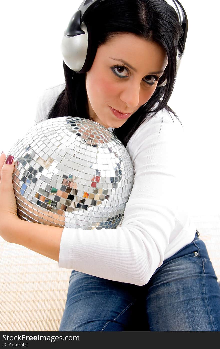 Close view of female listening music and holding disco ball with white background