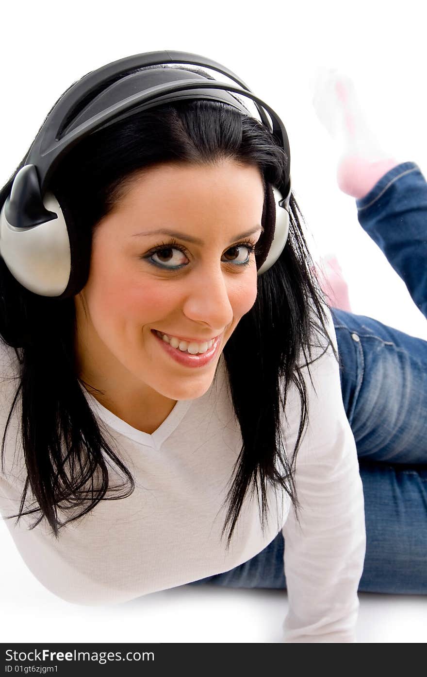 Front view of smiling female listening music on an isolated background. Front view of smiling female listening music on an isolated background