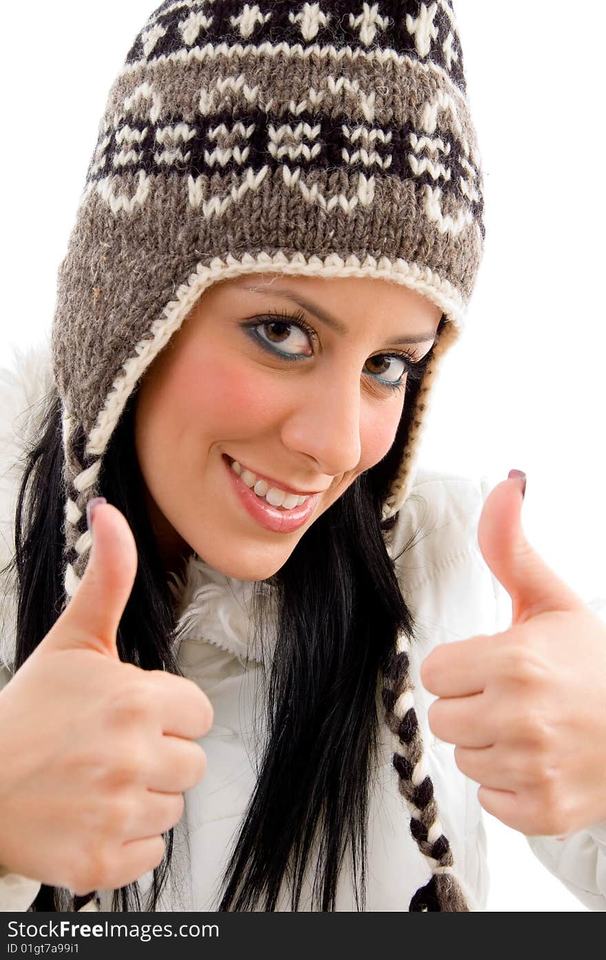 Front view of smiling woman with woolen cap and thumbs up on an isolated white background