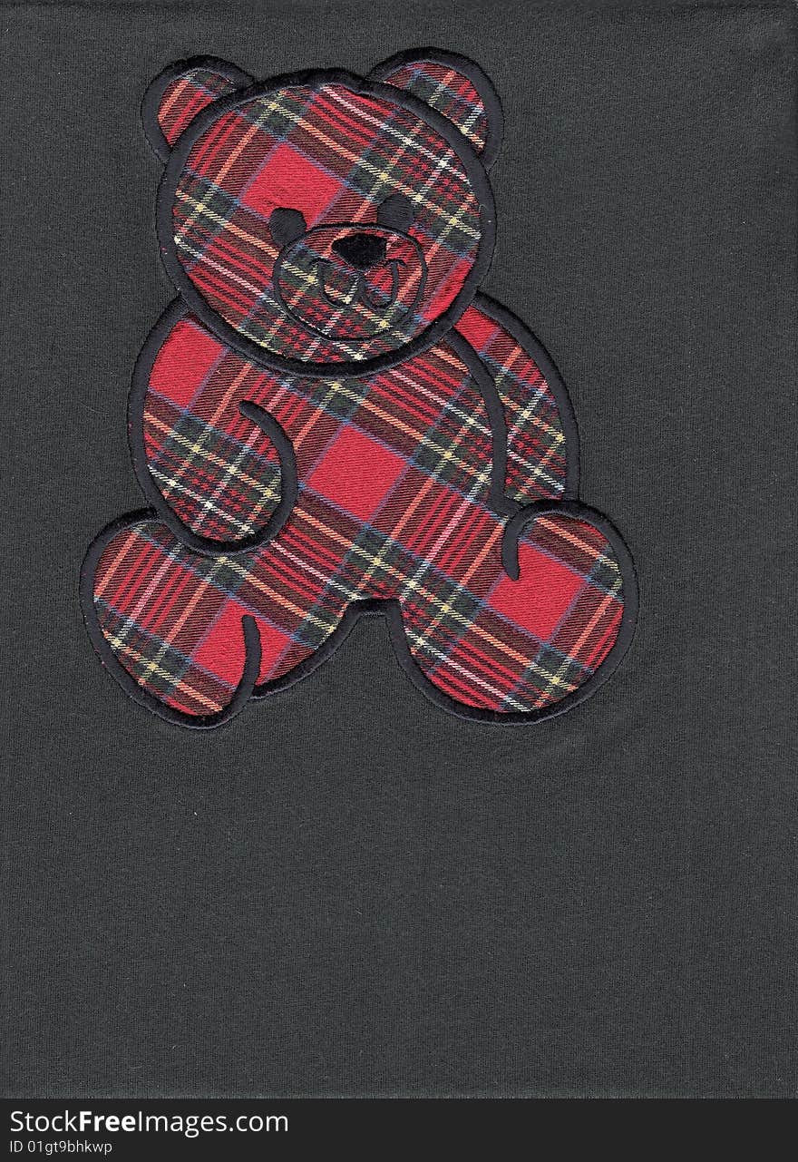 Scan of a scottish teddy bear on blue background