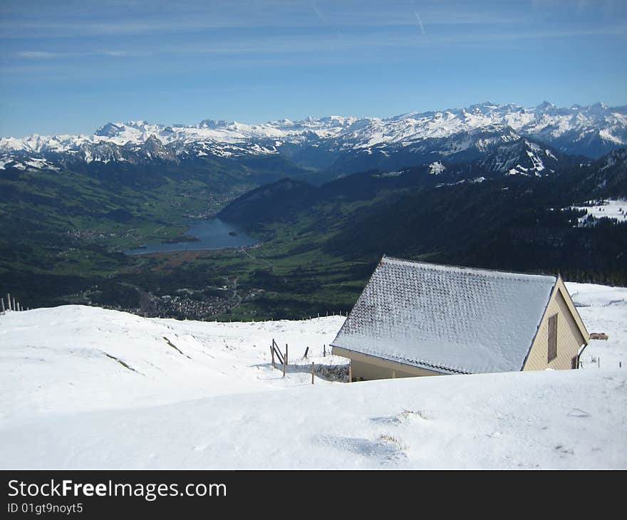 Snow coered house overlooking valley.