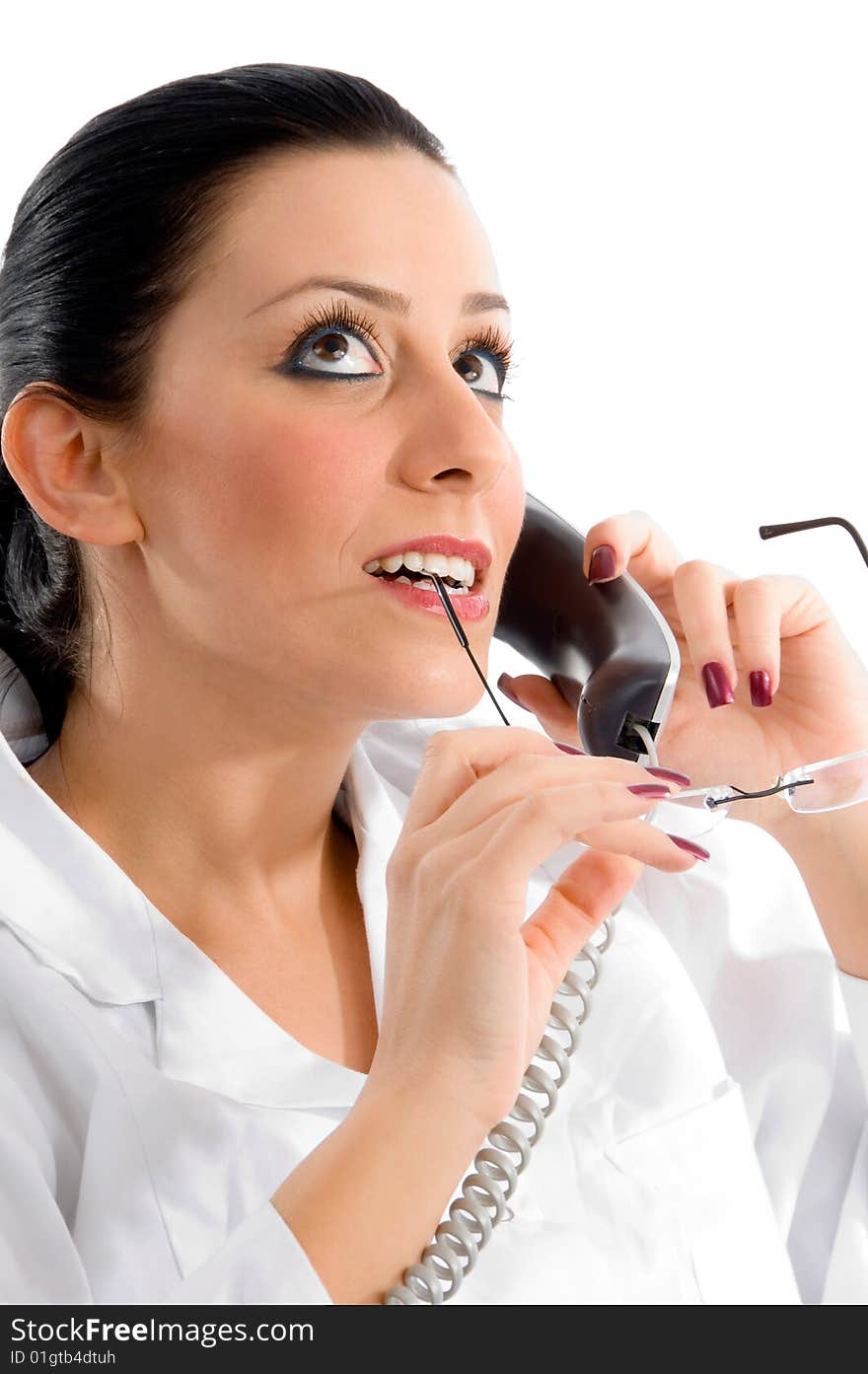 Side pose of doctor talking on phone and looking upward against white background