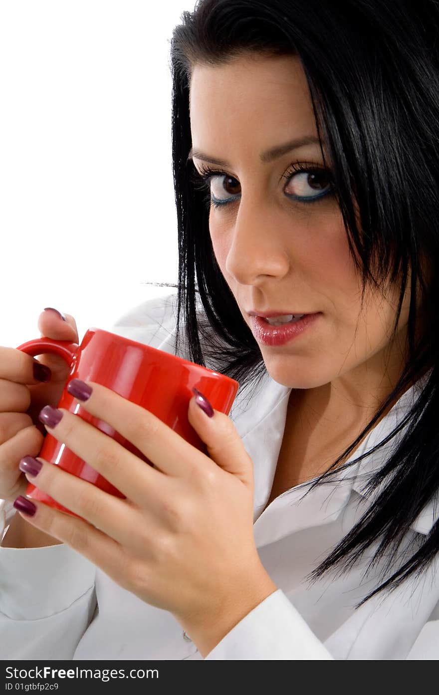 Side view of female doctor holding mug against white background. Side view of female doctor holding mug against white background