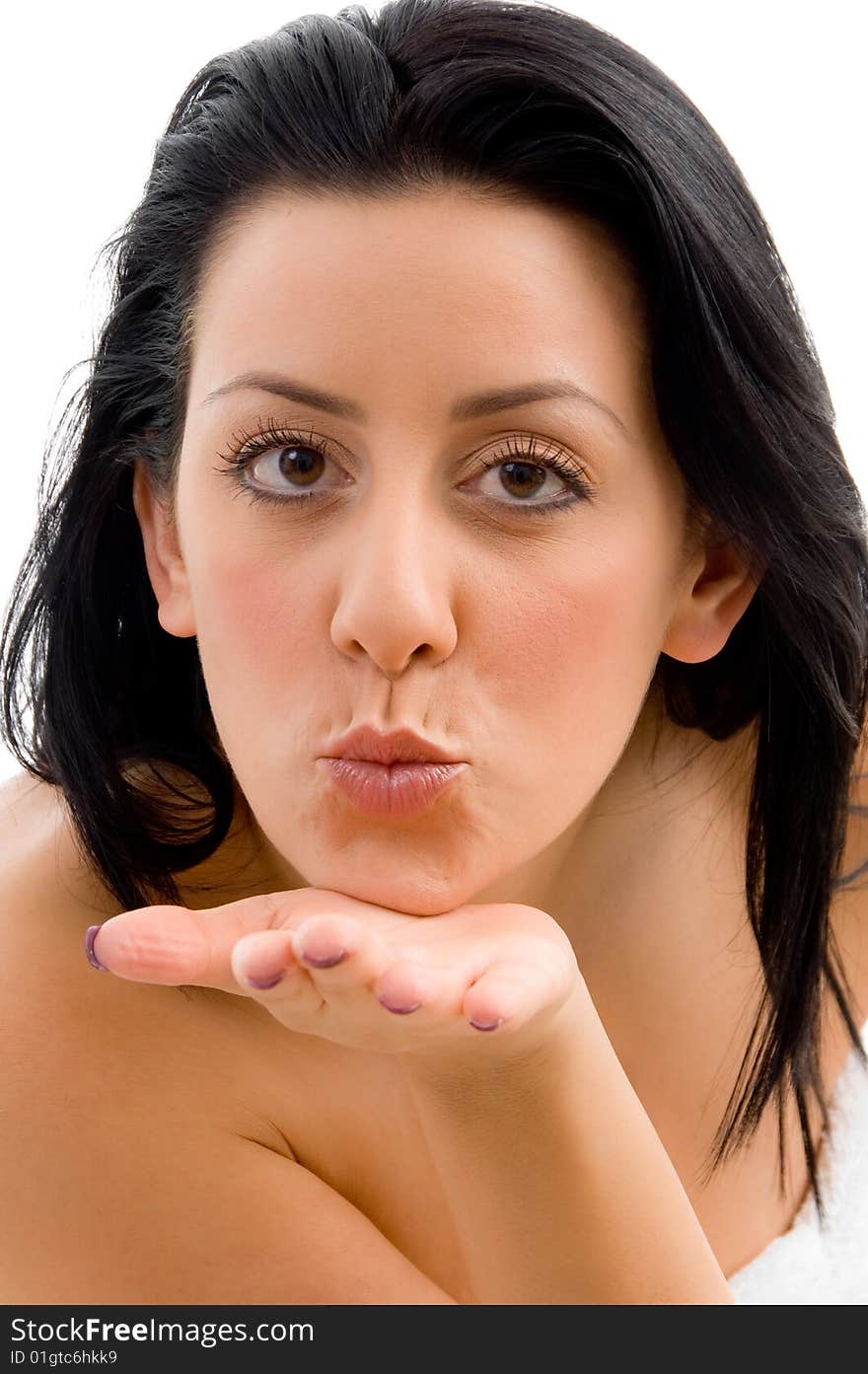 Front view of young female giving flying kiss in spa