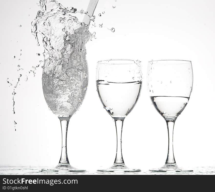 Glass with Splashing water. Coolness Drink. Glass with Splashing water. Coolness Drink