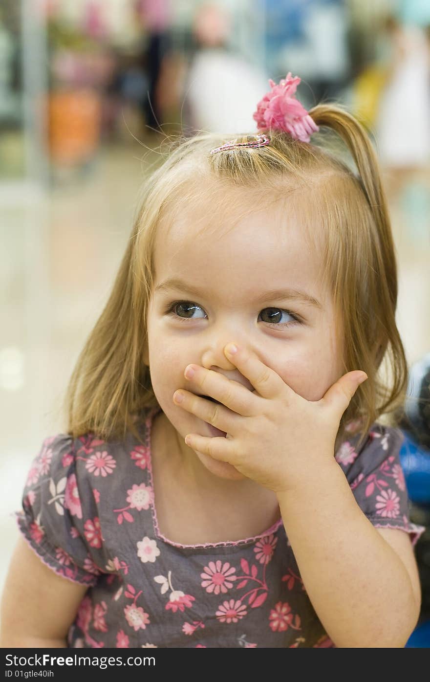 Baby girl smiling and having fun on a ride, blowing a kiss. Baby girl smiling and having fun on a ride, blowing a kiss