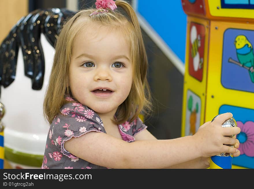 Baby girl smiling and having fun on a ride. Baby girl smiling and having fun on a ride