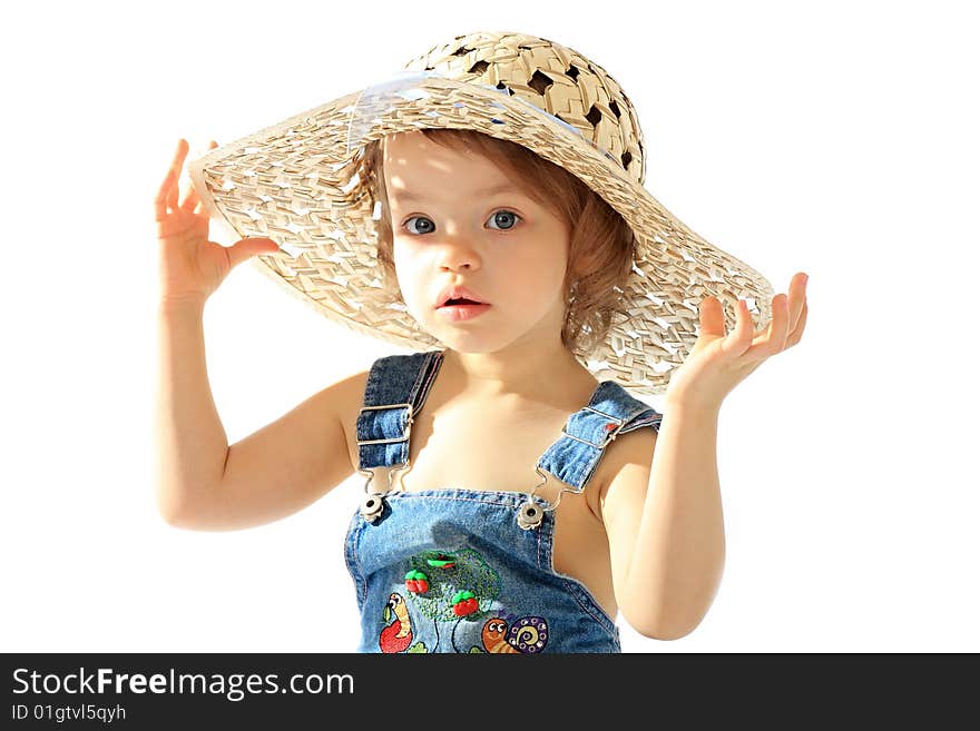 A little girl is in a straw hat. A little girl is in a straw hat.