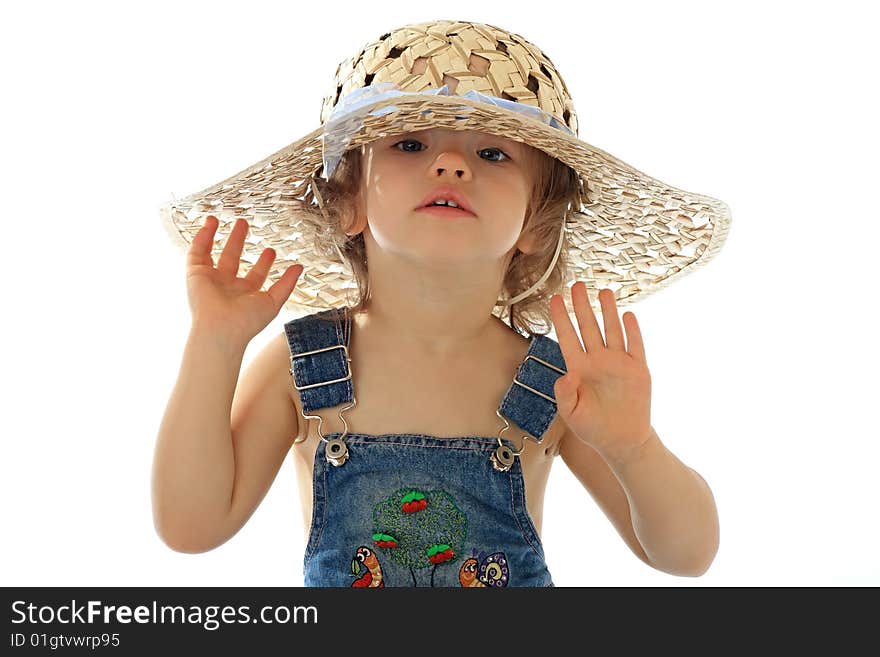 A little girl is in a straw hat. A little girl is in a straw hat.