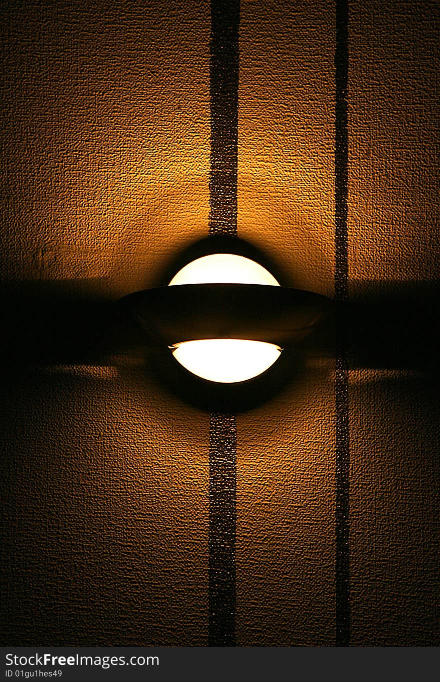 Modern lamp on a brown  wall  with a protuberant structure