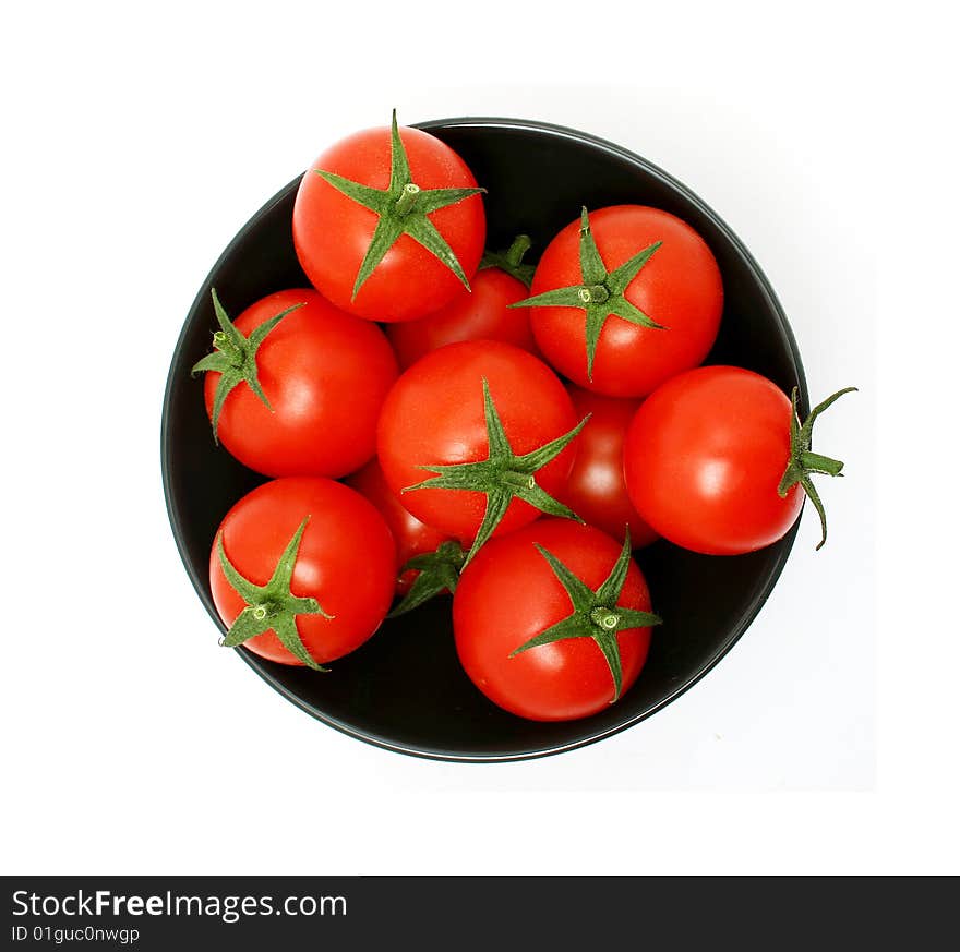 Tomatoes in a black bowl from above. Tomatoes in a black bowl from above