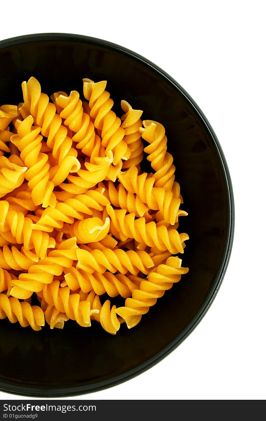 Pasta in a black bowl on white background. Pasta in a black bowl on white background