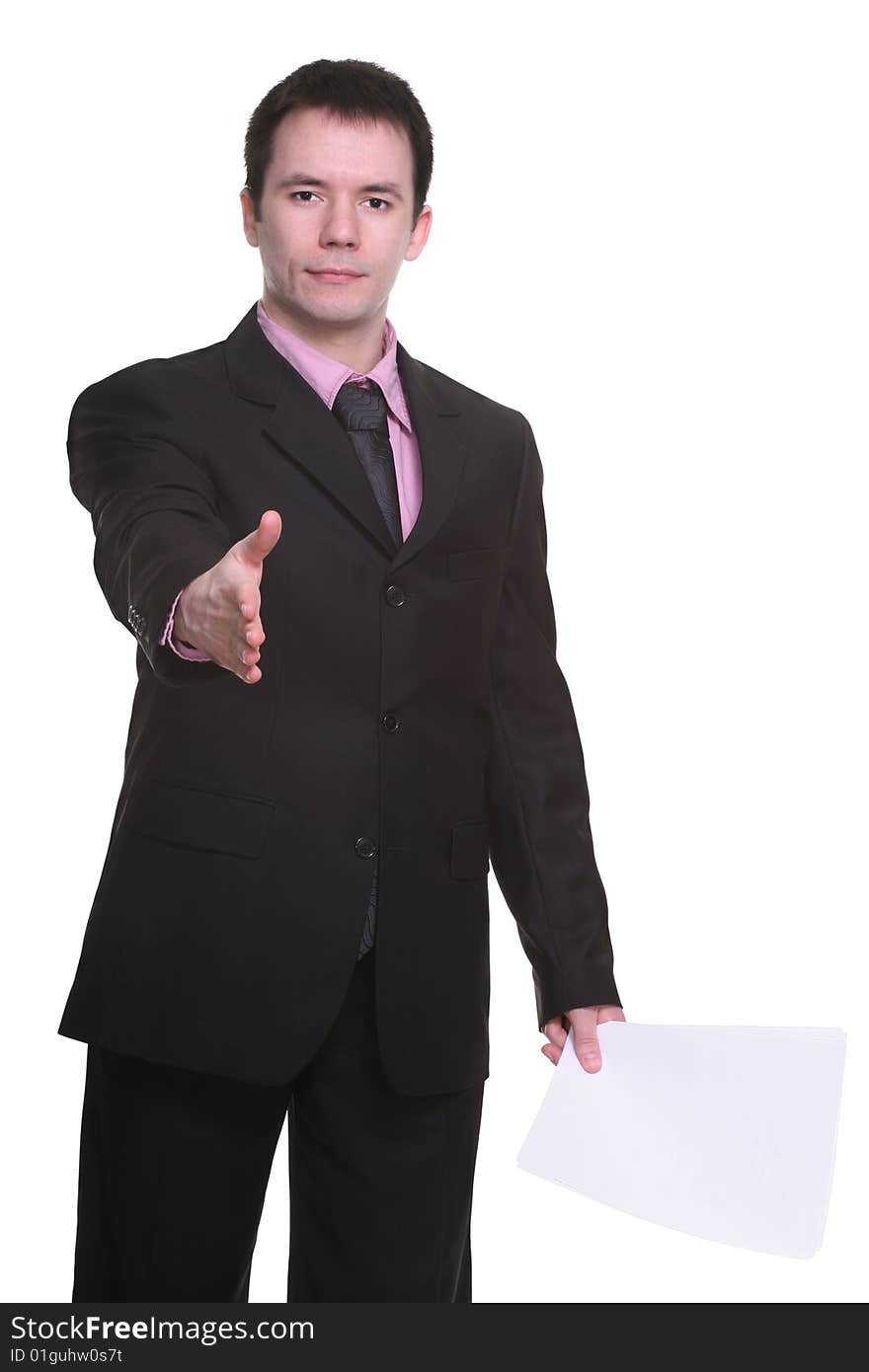 Young businessman offering a handshake, with papers in his other hand. isolated on white. Young businessman offering a handshake, with papers in his other hand. isolated on white