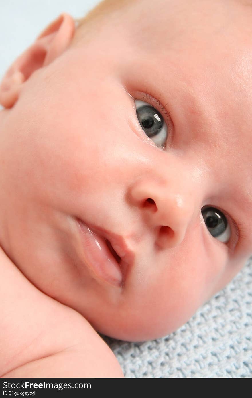 Month old baby boy on a light blue blanket