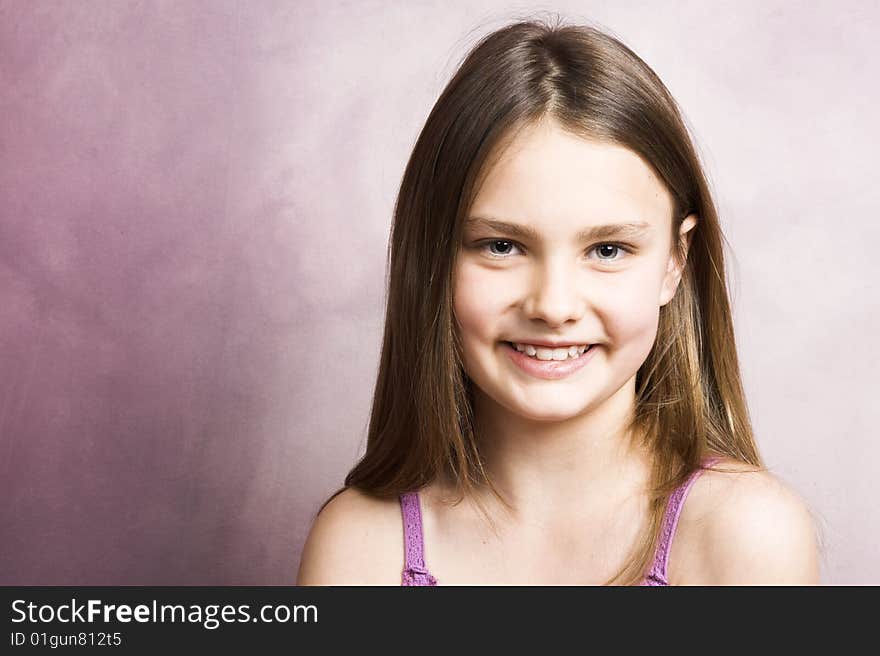 Beautiful young brunette against a pink background. Beautiful young brunette against a pink background