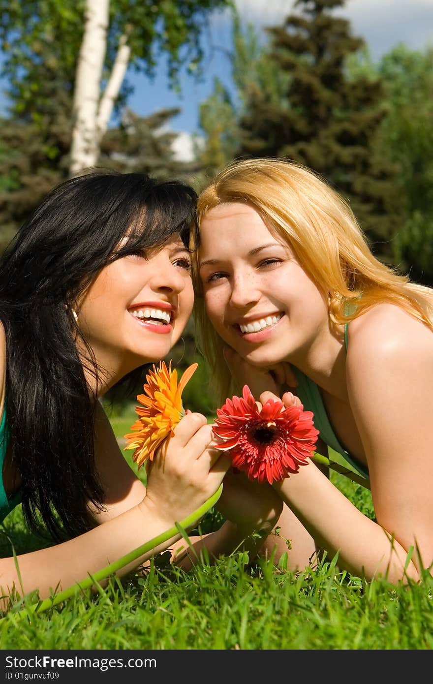 Pretty women rest in the park with flowers