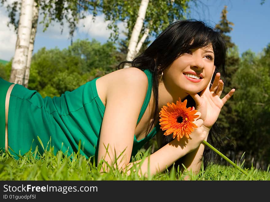 Pretty woman rest in the park with flower