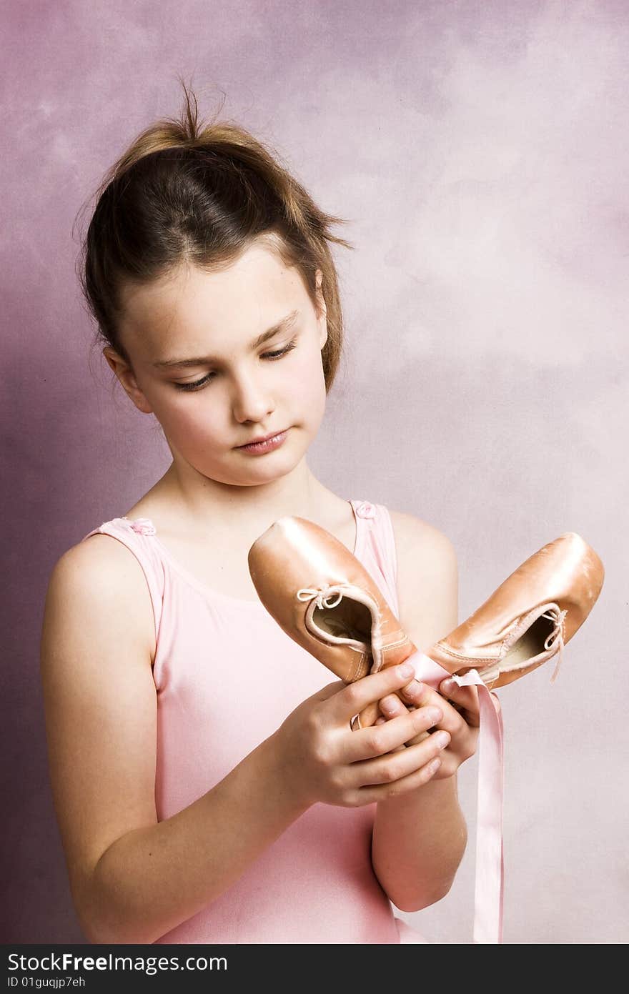 Young dancer wearing a pink costume with a beautiful expression