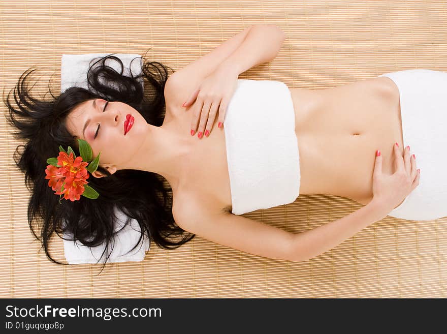 Lovely spa brunette with flowers