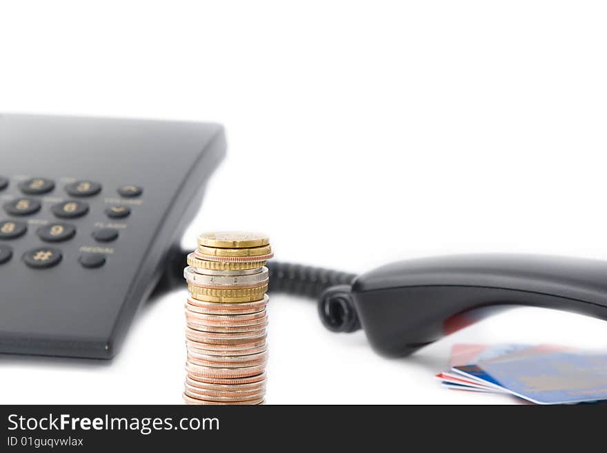 Communication business: coins stack and phone with credit cards in background