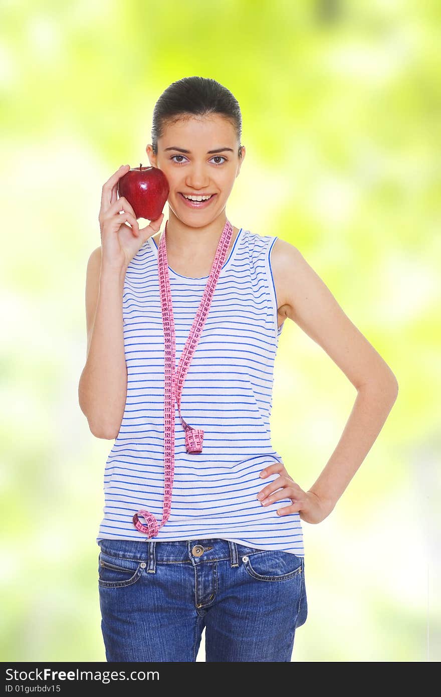 Portrait of cute young woman holding red apple and measuring tape. Portrait of cute young woman holding red apple and measuring tape