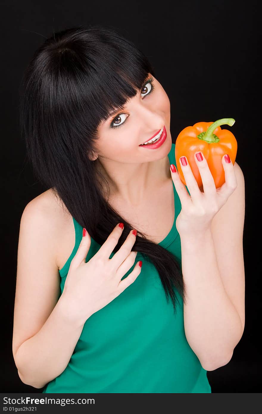 Cute girl with pepper on black background