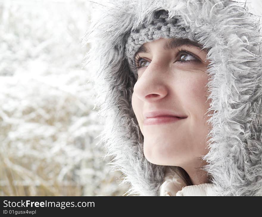 Teenage girl smiling up while out in the snow