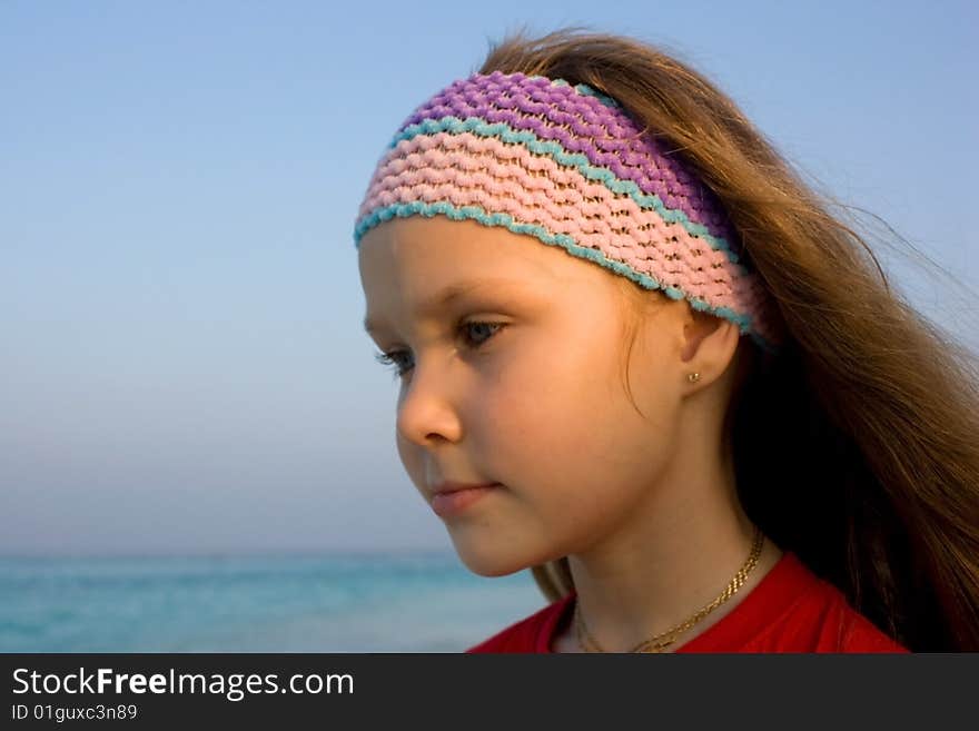 Girl looking to the sunset near ocean. Portrait. Girl looking to the sunset near ocean. Portrait.