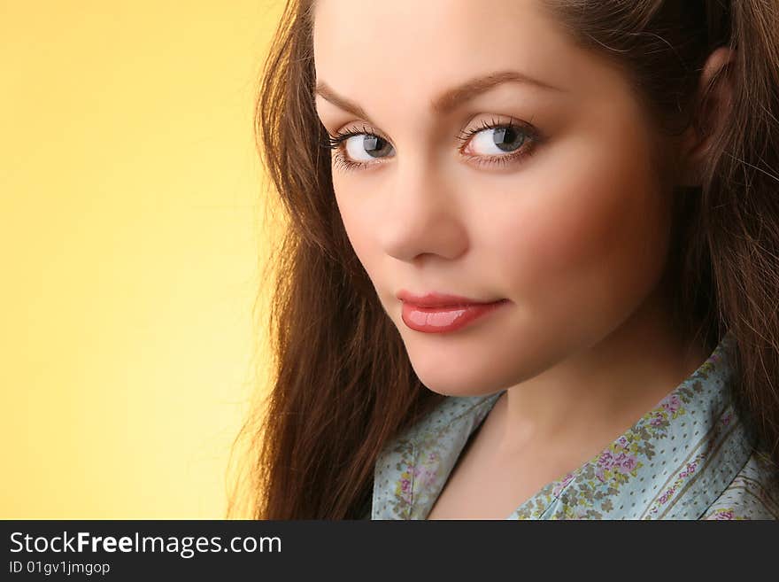 Closeup portrait of attractive young woman isolated on yellow background. Closeup portrait of attractive young woman isolated on yellow background