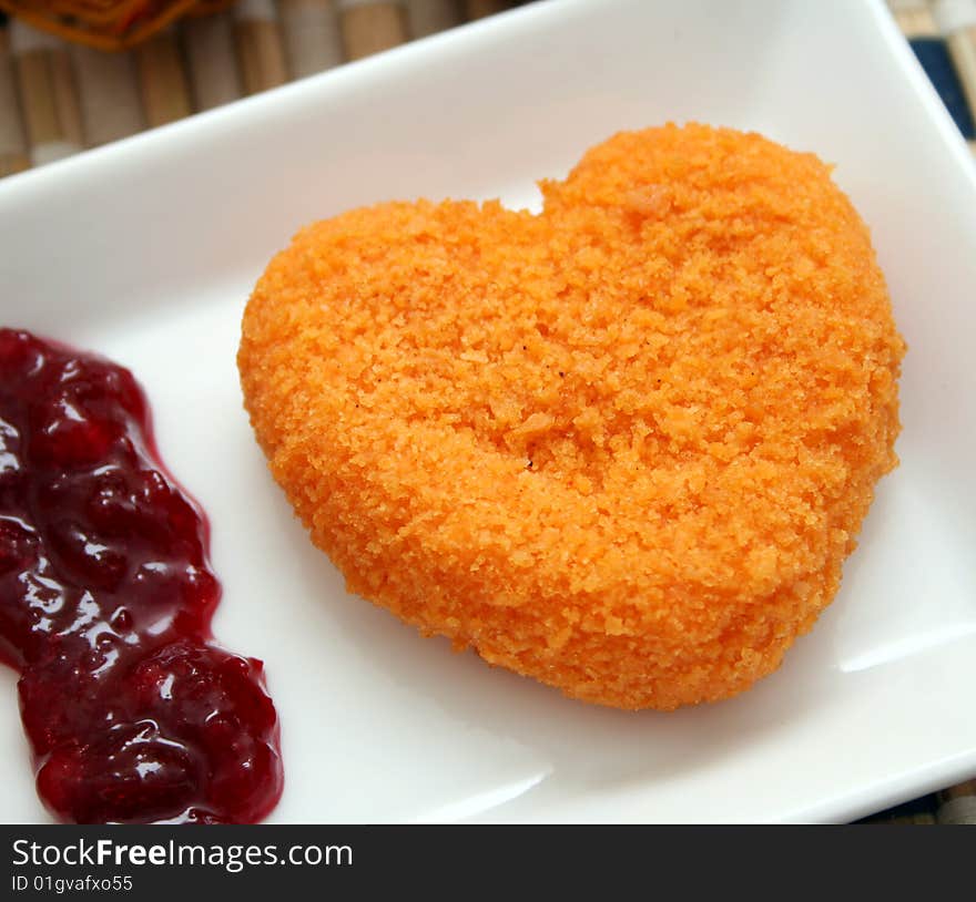 A meal of a cheese heart with fruits